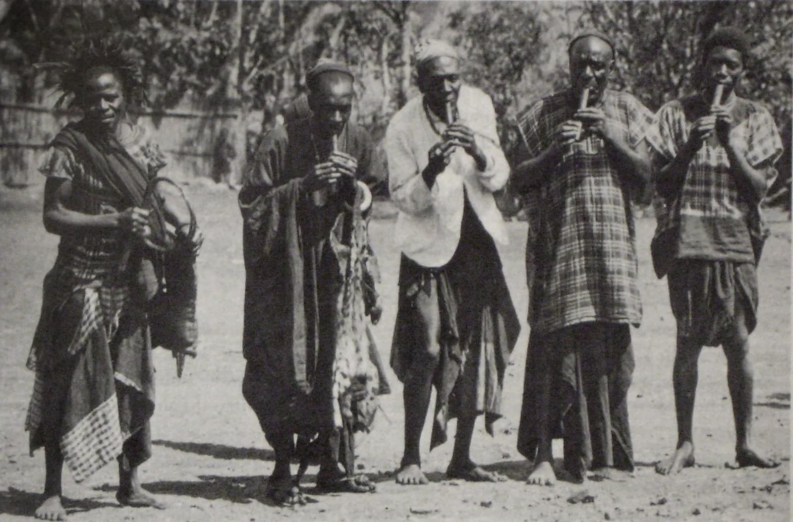 Cameroon: Four men play the holy "lela" flutes in Bali, Cameroon. The lela celebration is closely linked to the kingdom and members of the royal family direct the course